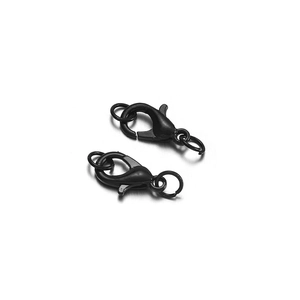Macro shot of two black alloy lobster clasps and jump rings for DIY jewelry projects