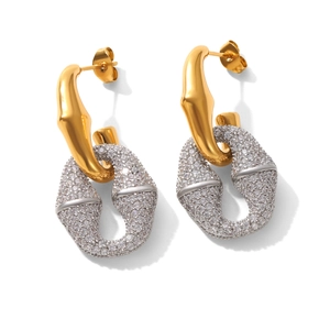 Close-up of gold and silver horseshoe earrings with micro-paved cubic zirconia stones