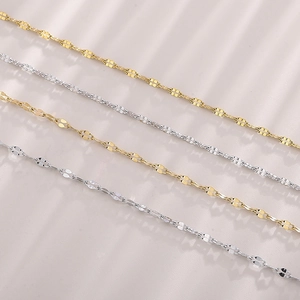 Classic stainless steel lip link chains in gold and silver finish displayed on textured surface