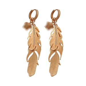 Elegant gold feather dangle earrings with diamond accents on a clean white background