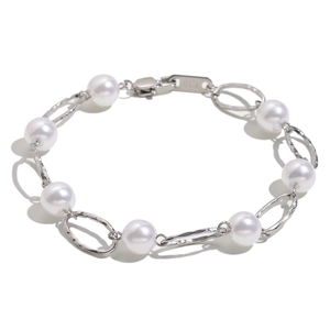 Elegant 18K gold plated stainless steel bracelet with white pearls on a white background