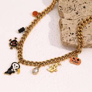Macro shot of 18K gold plated Cuban chain with ghost, pumpkin and skull charms