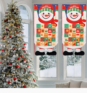 Detail of Christmas snowman advent calendars with numbered pockets in a festive home setting