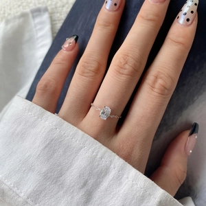 Close-up of minimalist S925 sterling silver chain ring with oval zircon worn on finger