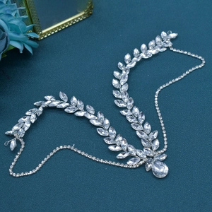 Detail of silver bridal forehead chain with leaf rhinestones and waterdrop pendant