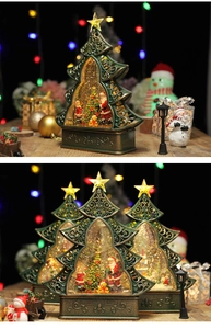 Detail of vintage Christmas tree crystal ball with Santa scene and glowing snow effects