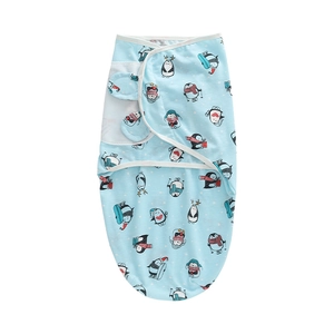 Detail showing soft light blue newborn swaddle featuring cute winter penguin patterns