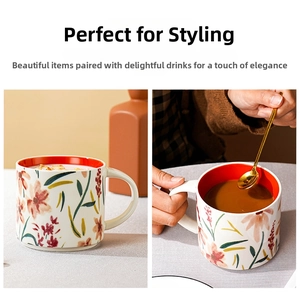 Close-up of floral ceramic mug with colorful hand-painted patterns and bright red interior