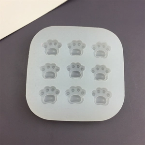 White silicone mold featuring 9 cartoon cat paw cavities for DIY baking and chocolate