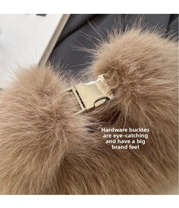 Detail of premium gold metal buckle on brown plush crossbody bag with soft faux fur texture