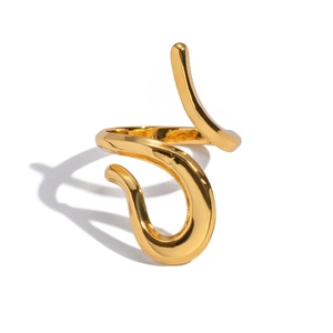 Close-up of a minimalist gold curved ring with a high-polished mirror finish