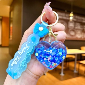 Detalle de llavero de corazón azul con lentejuelas de estrellas y correa Fairy Tales