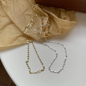 Detailed close-up of S925 silver link necklaces in gold and silver floral designs