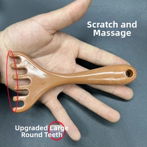 Macro shot of brown scalp massage comb featuring smooth large round teeth for comfort