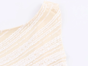 Macro shot of white sequin stripes on mesh fabric for a fitted sleeveless dress
