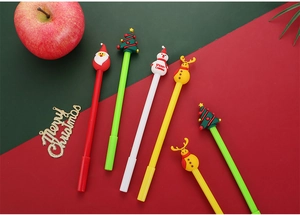 Flat lay of Christmas cartoon pens with Santa, Reindeer and Tree on festive background