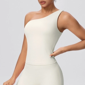 Detail view of double-sided brushed fabric on ivory yoga bra with one-shoulder design