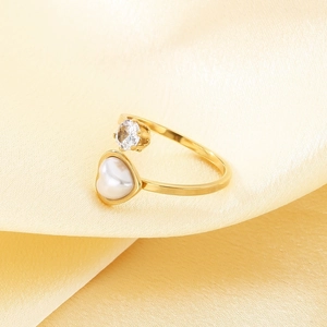 Gold open ring featuring heart-shaped pearl and round zircon on warm silk fabric