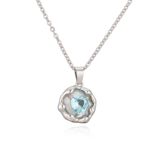 Macro view of 925 silver heart necklace featuring a bright blue aquamarine gemstone