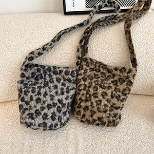 Detail view of plush leopard print bucket bags in grey and brown for autumn style