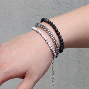 Close-up of a men's layered bracelet set with rose stone beads and titanium steel chains