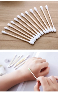 Detailed view of dual-tip wooden cotton swabs for makeup and skincare application