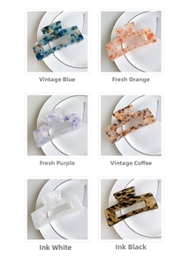 Set of six colorful rectangular claw clips with marble textures and floral patterns