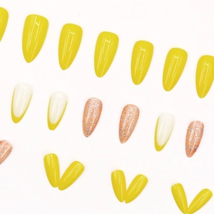 Yellow French stiletto press-on nails with glitter accents and vibrant almond shape design