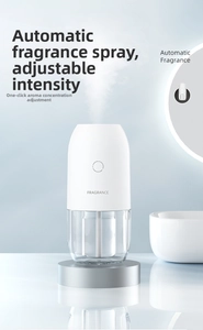 Close-up of smart fragrance diffuser with adjustable mist intensity on soft blue background
