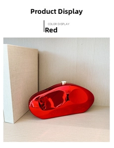 Detailed view of red mirror finish irregular stone clutch bag with gold metal clasp