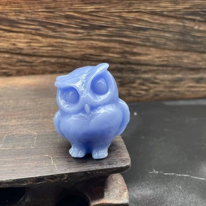 Close-up of a 3.5cm blue natural stone owl figurine with a smooth polished finish