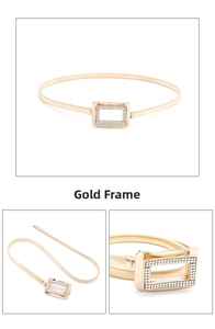 Detailed view of gold chain belt with rhinestone-encrusted rectangular buckle closure