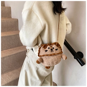 Detailed knit texture of handmade lion crochet crossbody bag with drawstring closure