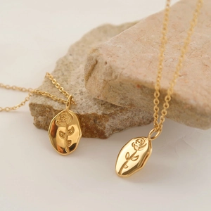 Vintage stainless steel oval pendant necklace with embossed rose flower design