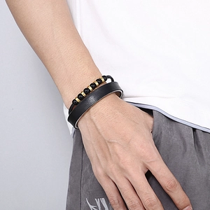 Men's double-layered bracelet with black leather band and golden beaded accents