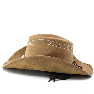 Macro shot of brown leather cowboy hat with silver rivets and white decorative stitching