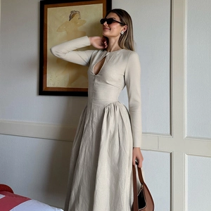 Detailed texture of beige long sleeve dress with cutout design and high waist fit