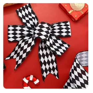 Detail of black and white lattice plaid bows on red background for Christmas decor