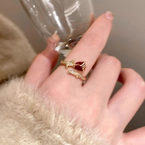 Macro detail of 14K gold plated red rose ring with delicate crystal leaves and petals