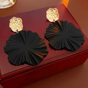 Chic geometric black flower petal drop earrings with textured gold accent studs