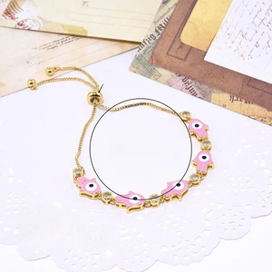 Detailed view of the Hamsa hand charm with pink oil drip and white zircon accents