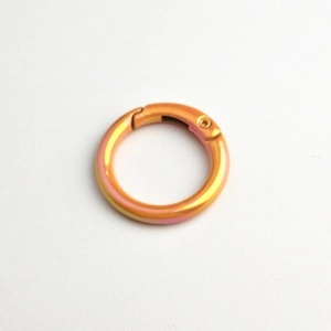 Close-up of a gradient-colored metal spring ring clasp with a vibrant iridescent finish
