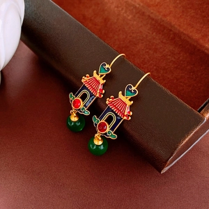 Detail of vintage palace style heart earrings with Chinese architecture and enamel
