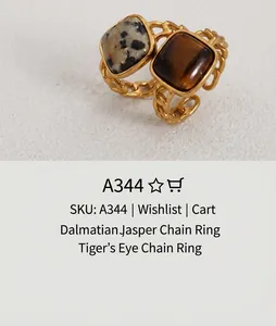 Detail of vintage gold chain rings featuring square tiger eye and spotted natural stones
