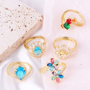 Detailed close-up of adjustable gold-plated rings with colorful cubic zirconia flowers