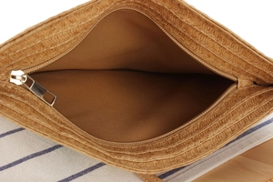 Close-up of paper rope woven bag with zipper closure and brown polyester lining detail