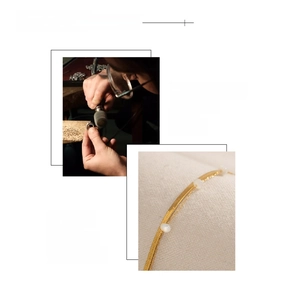 Detailed macro view of 18K gold plated flat snake chain with round shell bead accents
