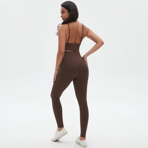 Close-up of chocolate brown high-waist yoga pants and cross-back sports bra set
