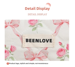 Detail of quilted cosmetic bag with pink rose patterns and Beenlove woven brand label