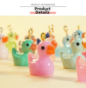 Macro detail of colorful resin duck charms with gold metal hooks for DIY jewelry making